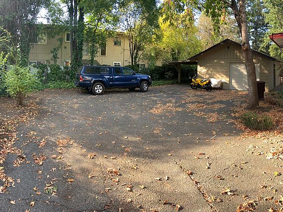 View of backyard, entrance to kitchen, and covered spot (attached to garage)