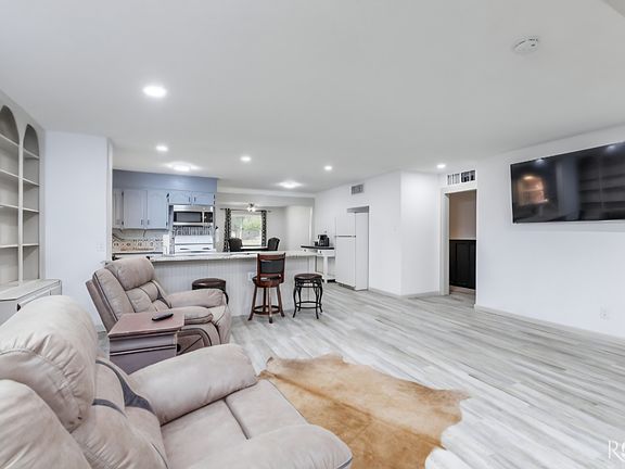 Living Room with 65" Smart TV and Fireplace.