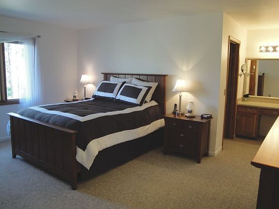 Master Suite with vanity, walk-in closet and full tiled bathroom