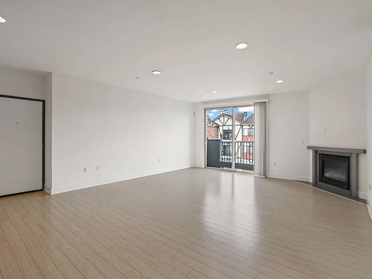 Spacious Living Room with Electric Fireplace and Patio Access