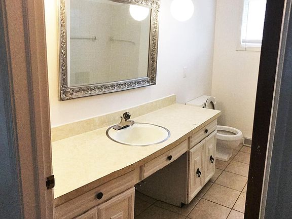 Large bathroom with a tub and unique fixtures