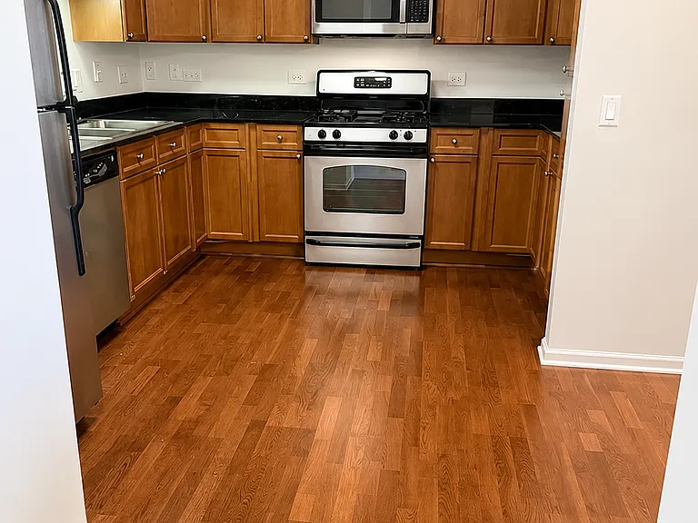 Well equipped kitchen with hardwood floors