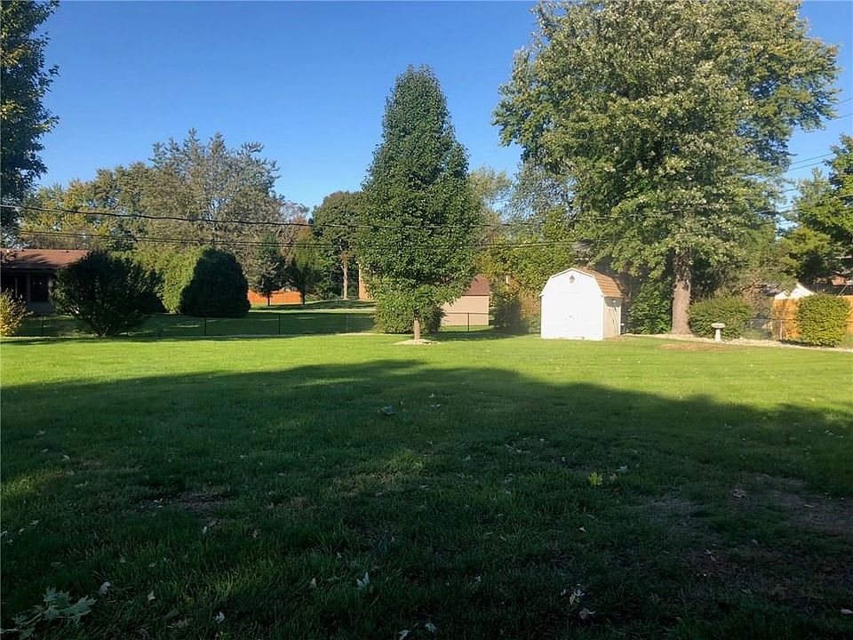 View of the park-like back yard from house includes mini barn.