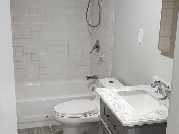 Bathroom with new floors, new toilet & new vanity w/ Carrera marble counter!
