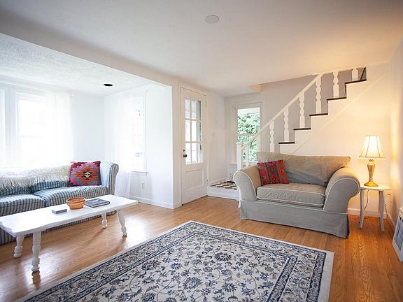 Another living room photo showing the staircase to the upstairs.