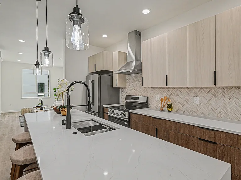 Kitchens is complete with huge island, stainless steel appliances included built in microwave, quartz countertops, stone backsplashes, full range hood, high quality fixtures.