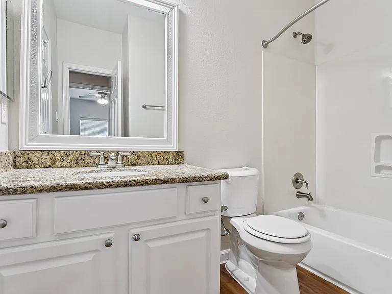 Elegant bathroom with sleek countertop, modern fixtures, and a pristine bathtub for a relaxing experience. Elegant bathroom with sleek countertop, modern fixtures, and a pristine bathtub for a relaxing experience.