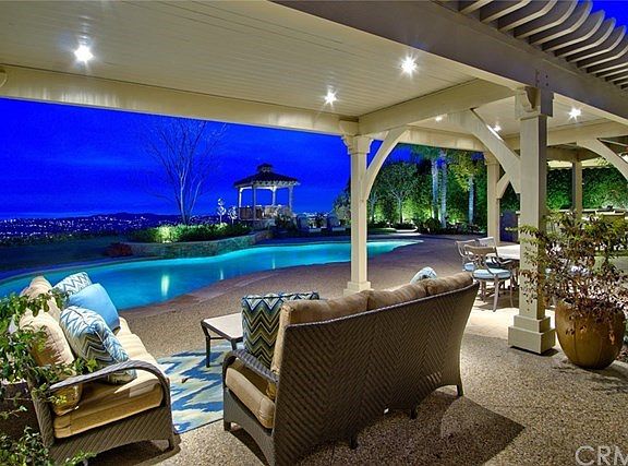 Pretty arbor spans back of home, offering shady respite & sun-filtered enjoyment!