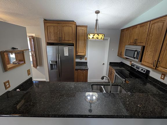 Granite counter tops with realwood cabinets and a lasy susan