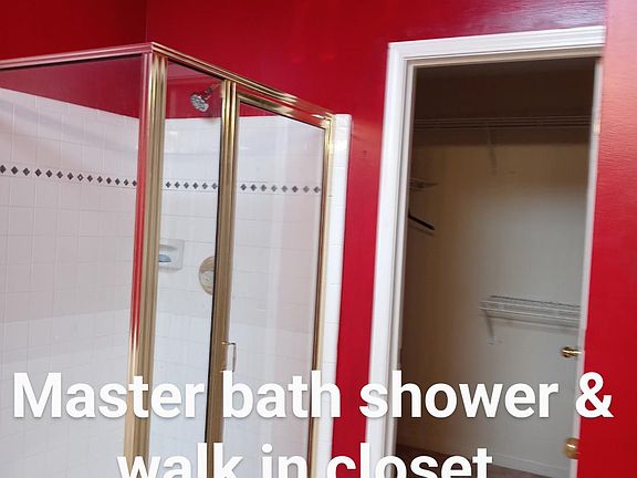 Master bathroom with shower and walk in closet