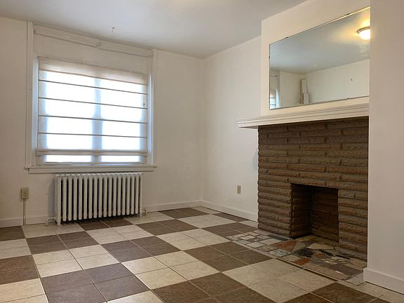Bedroom A on the first floor features a decorative fireplace and a closet.