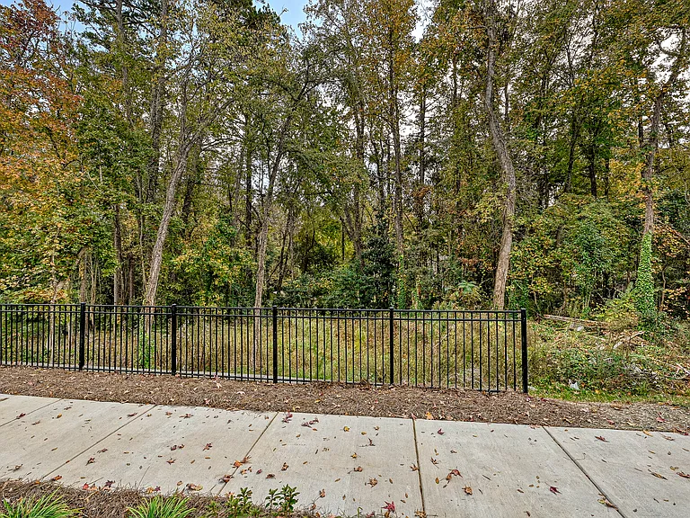 faces open wooded area at back of property