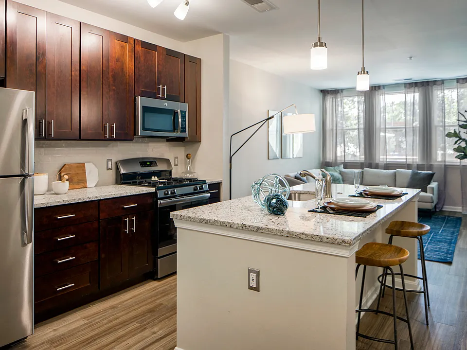 Culinary kitchens featuring Shaker cabinets, light-colored countertops and stainless steel appliances