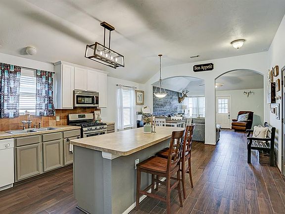 Beautiful open concept home with gorgeous wood tile flooring throughout main living space.