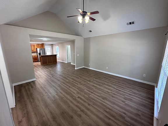 Spacious living room with open floor plan leading to the kitchen