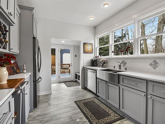 Tons of windows to let in all that natural light and a convenient sitting bench with storage by the back door.