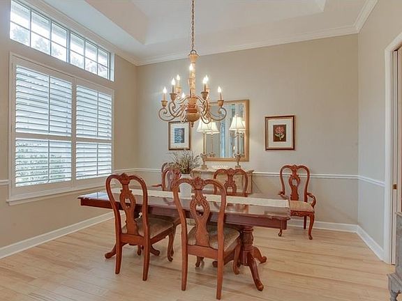 Casual elegance with crown molding, chair rail, and tray ceiling
