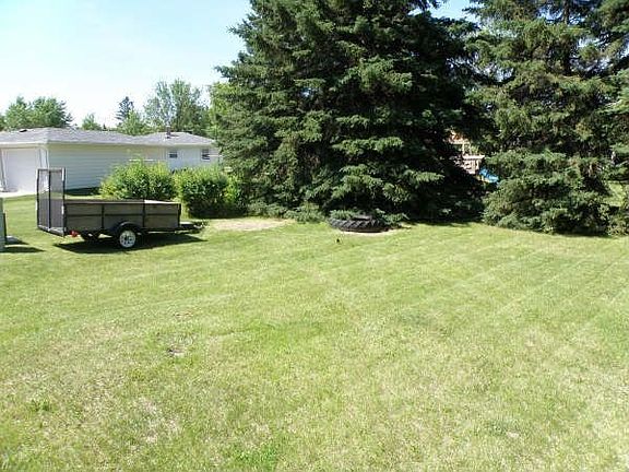 Backyard beyond trees to alley