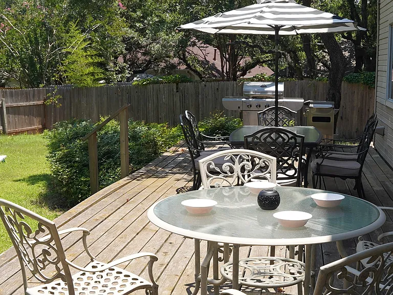 Plenty of seating on backyard deck plus gas grill