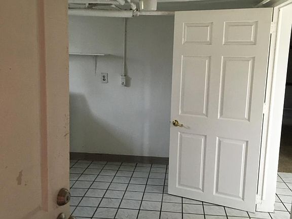Apartment entrance into mud/laundry/bath area. Door to kitchen.