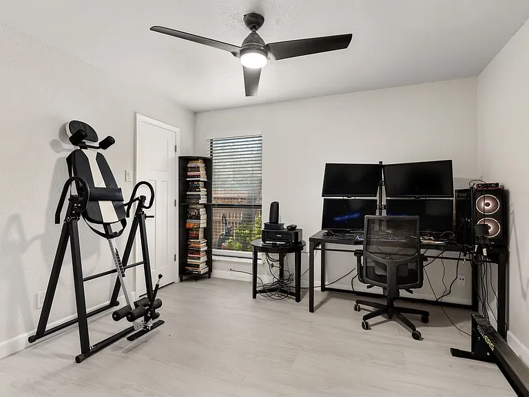 Office space with ceiling fan and light hardwood / wood-style flooring