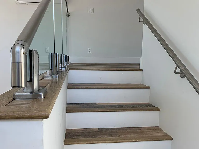 Glass wall and stairway to loft.