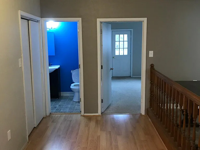 View of half bath entry and bedroom entry from living area.