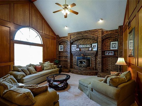Cozy living room with vaulted ceilings and beautiful brick fireplace.
