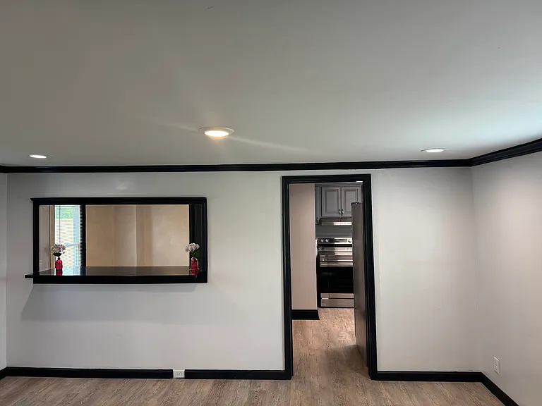 Amazing view of the living room, serving hatch and entry door into the kitchen