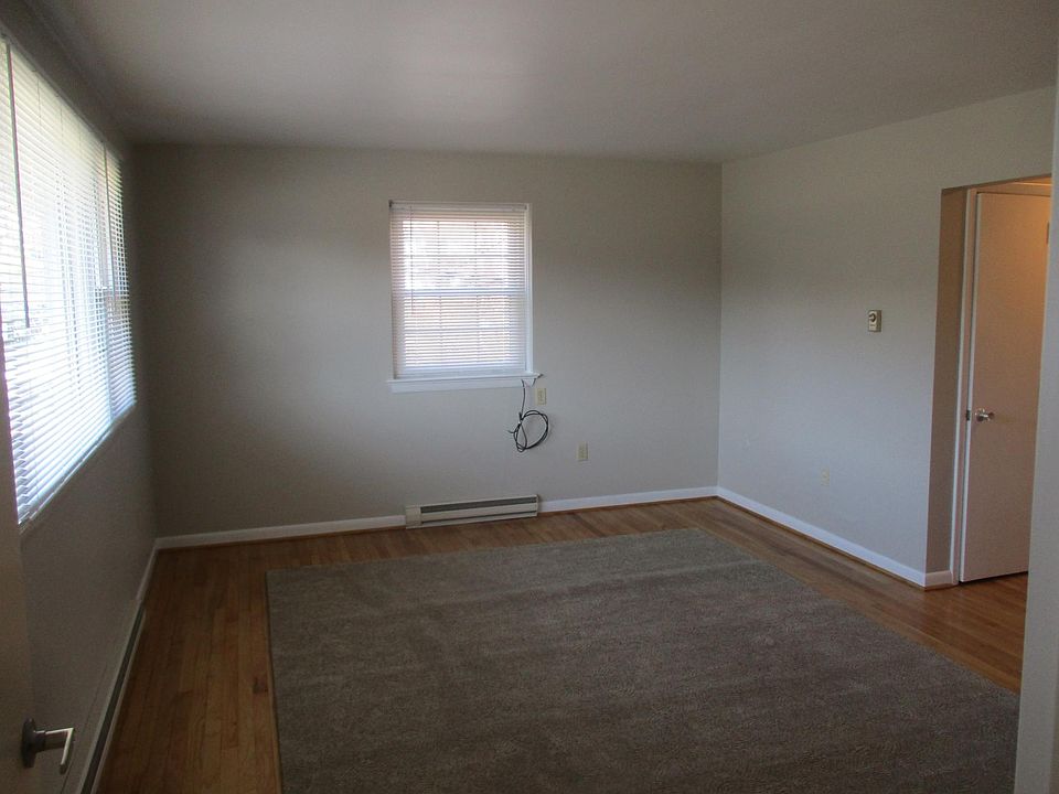 Living room with hardwood floors and area carpet provided