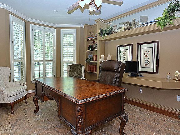 Study with built-in computer desk, wood and tile flooring, Bay Window, and Plantation Shutters.