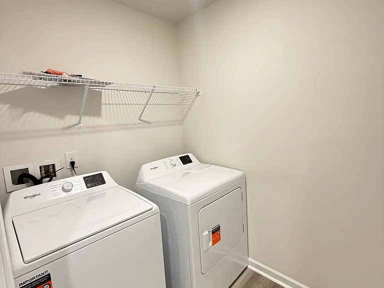 Laundry room with washer and dryer included.