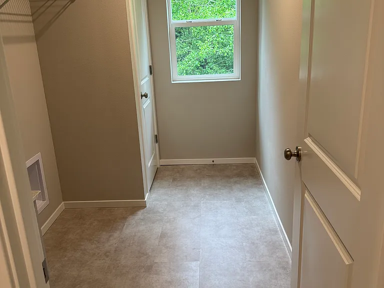 Laundry room, next to the master bedroom. View of the green area facing the estate next door.
