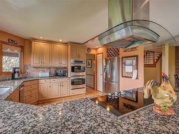 GRANITE COUNTERS, DOUBLE OVEN, SS APPLIANCES, HARDWOOD FLOORS.