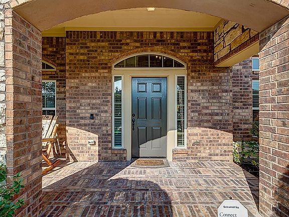 Freshly painted front door with side by side lead glass windows and a matching glass arch.