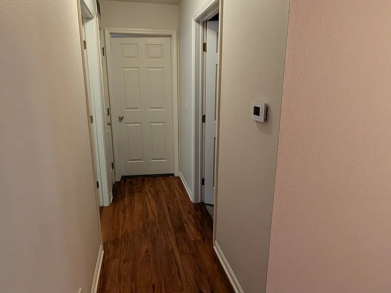 Hallway view from entryway. Bedroom #1 is the door to the left, Bathroom #1 is the door to the right, and Master Bedroom w/ attached Bathroom #2 is straight ahead.