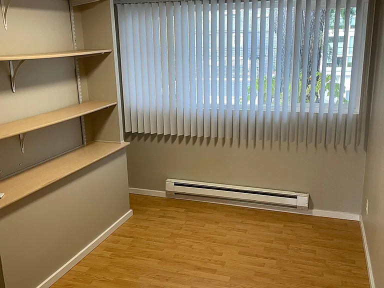2nd bedroom with built in book shelves also great for office