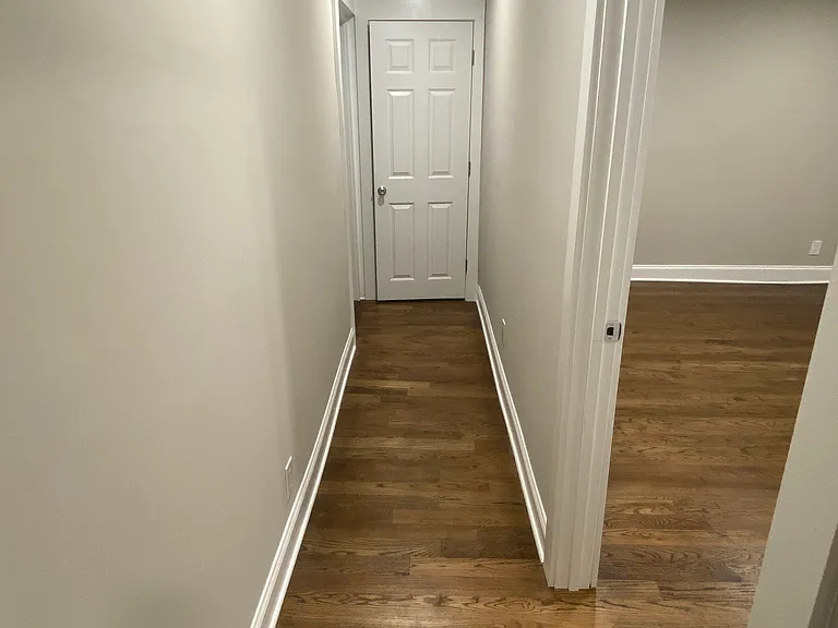 Looking down hallway. Bedroom is to the right and bathroom is at the end to the left. There is a coat closet at the end of the hallway for extra storage and jackets/coats/etc.