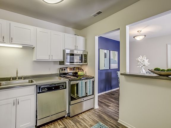 Silver appliances and beautiful white cabinets at Arbor Land