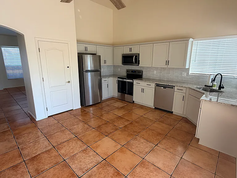 Bright eat-in kitchen with vaulted ceiling and abundant natural light