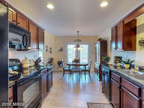 Kitchen with upgraded cabinets and tile floors