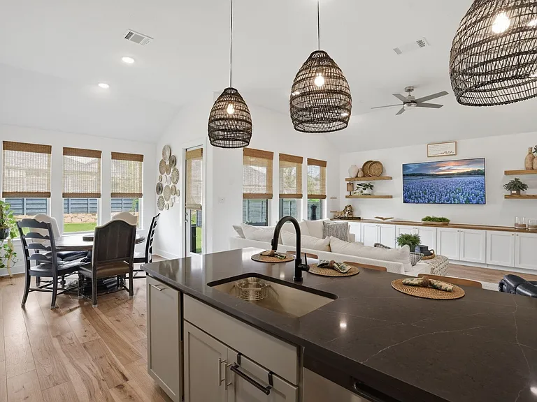 Chic quartz countertops compliment the black faucet & stainless cabinet hardware.