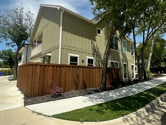 Fenced in dog run with doggy door
