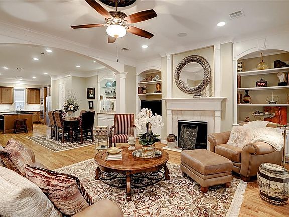 Ideal open concept geared for entertaining .... you will note ceiling fan and recessed cans, arched column detail, and view to the dining room and kitchen.