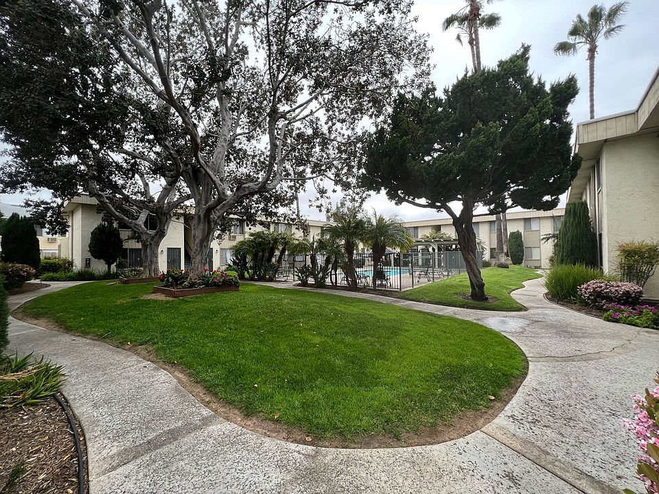 Beautiful trees, walkways and pool area at IKARIA Apartments in Santee, California.