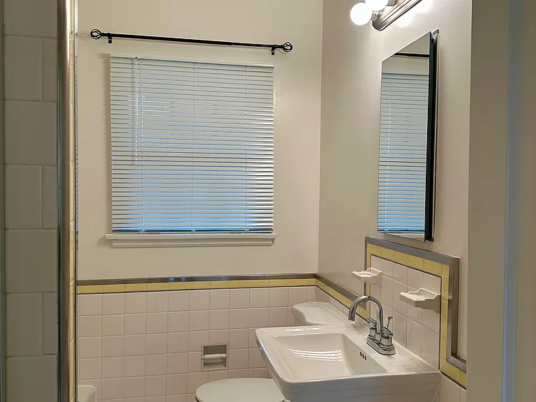 Bathroom entryway, white blinds, classic lighting