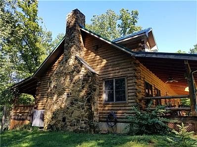 Beautiful on every side, the stone fireplace, metal roof, and exquisite front and back porches are picturesque.