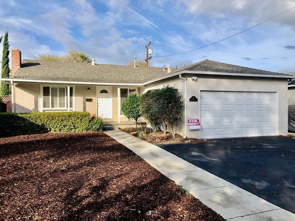Main entrance with front yard view (attached 2-car garage and street parking)
