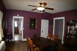 Dining room with hardwood floors open to living room