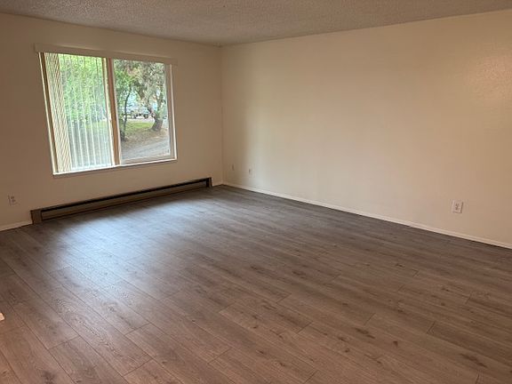 Spacious living/dining room with entry hall, dbl pane, vinyl windows and engineered wood floors.